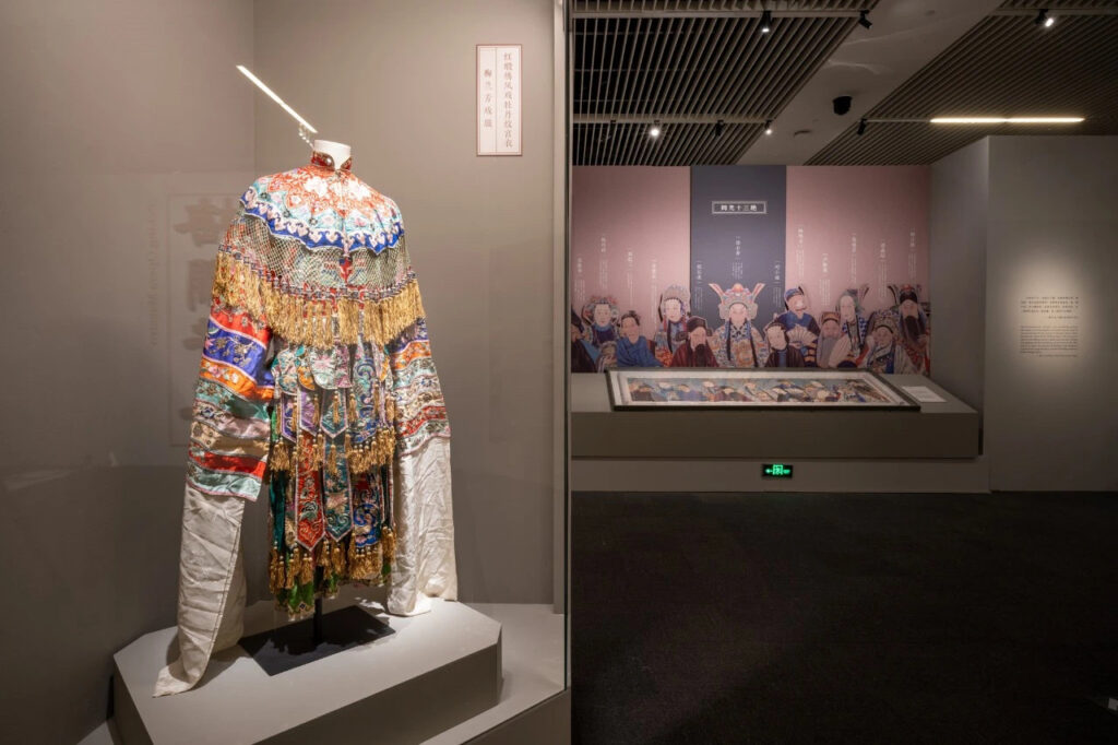 Peking opera costume and Tongguang Shisan Jue master painting displayed at National Museum of China Mei Lanfang exhibition, illuminated by professional museum track lighting