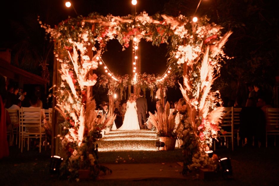 Outdoor wedding venue with string light canopy overhead