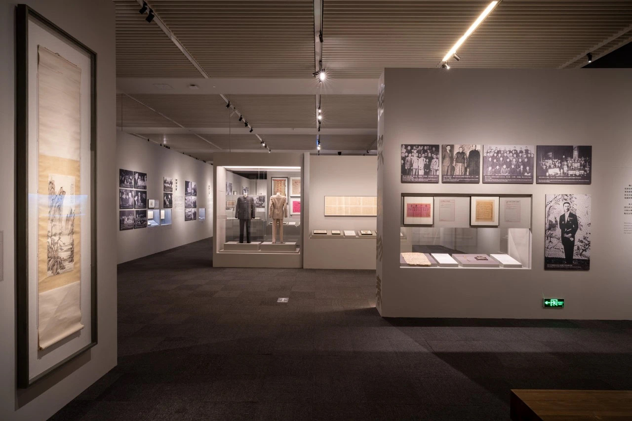 Museum track lighting system illuminating traditional Chinese calligraphy scrolls and Peking opera artifacts at National Museum of China Mei Lanfang exhibition