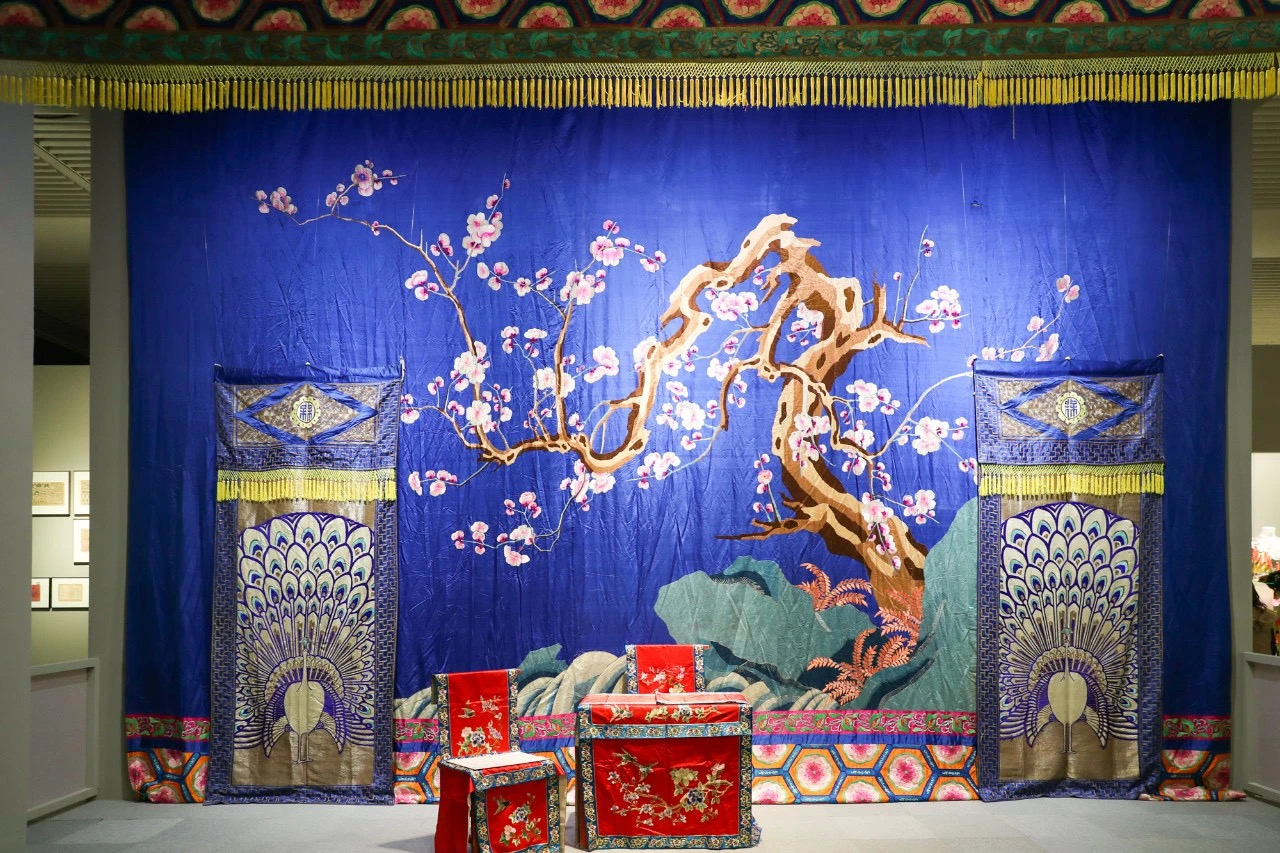 Traditional Chinese opera stage set with plum blossom backdrop at National Museum of China Mei Lanfang exhibition, referencing Mei Lanfang name plum orchid fragrance