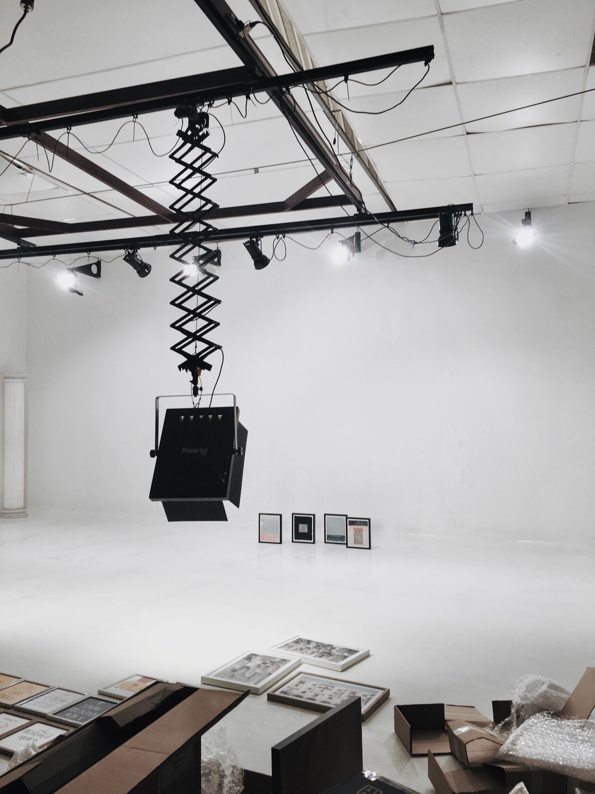Contemporary art gallery with framed artwork on white walls under focused high-CRI lighting
