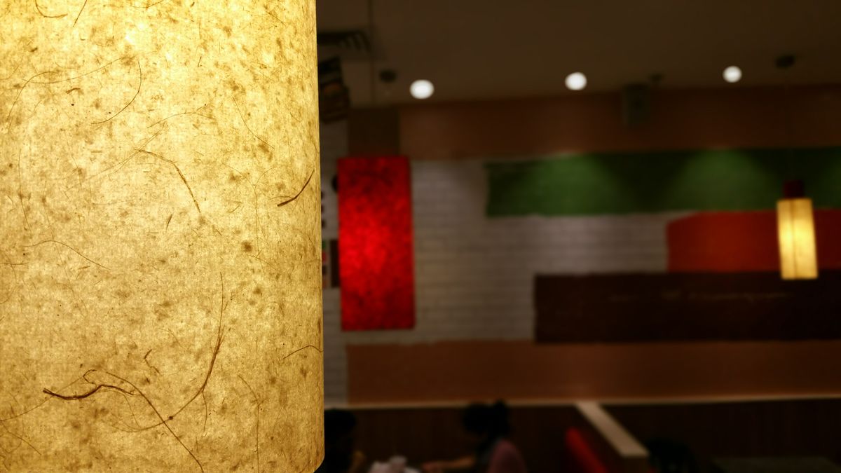 Cozy restaurant interior with warm ambient track lighting over dining tables