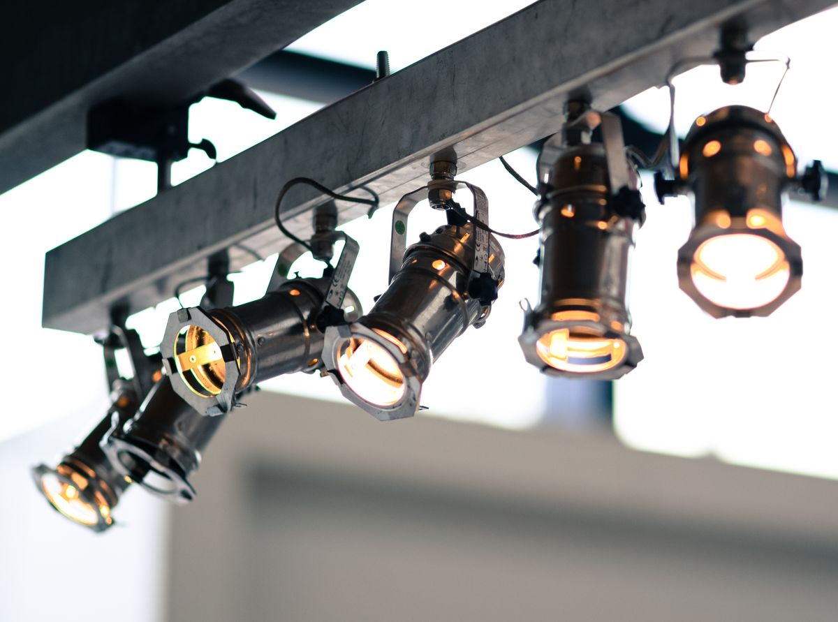 Commercial track lighting heads mounted on a ceiling rail spotlighting interior displays