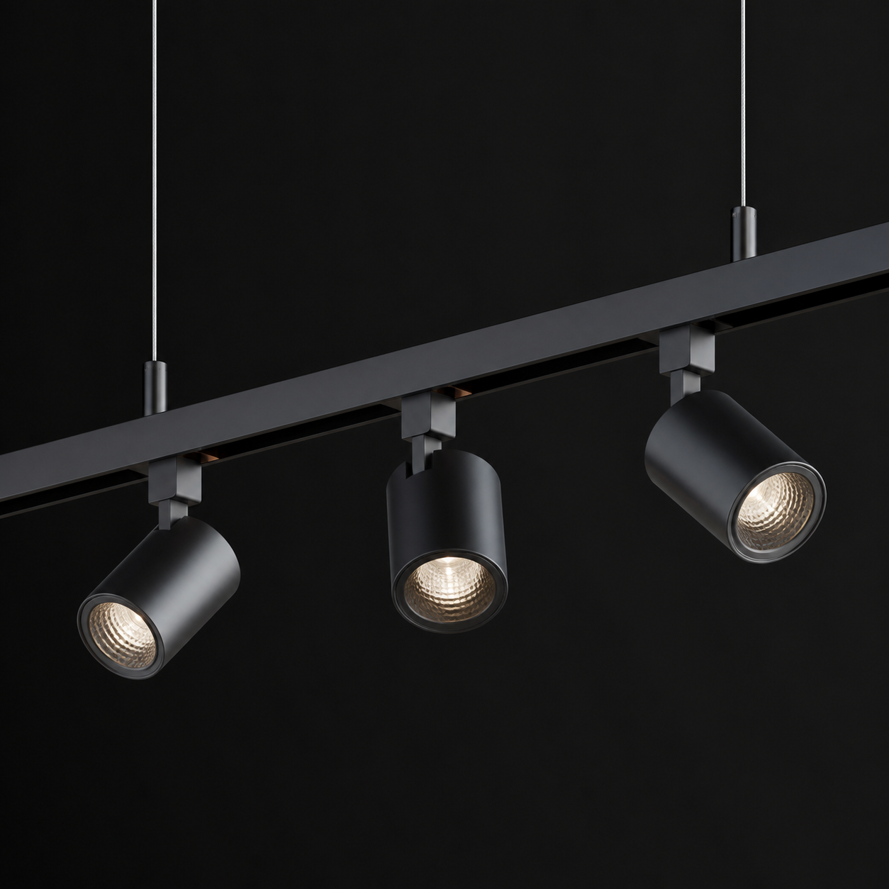 suspended track lighting on cables from a high ceiling
