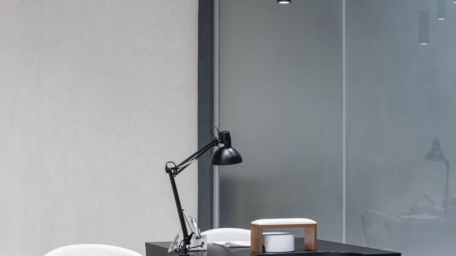 Modern office interior with ceiling track lighting providing 500 lux task illuminance on work surfaces