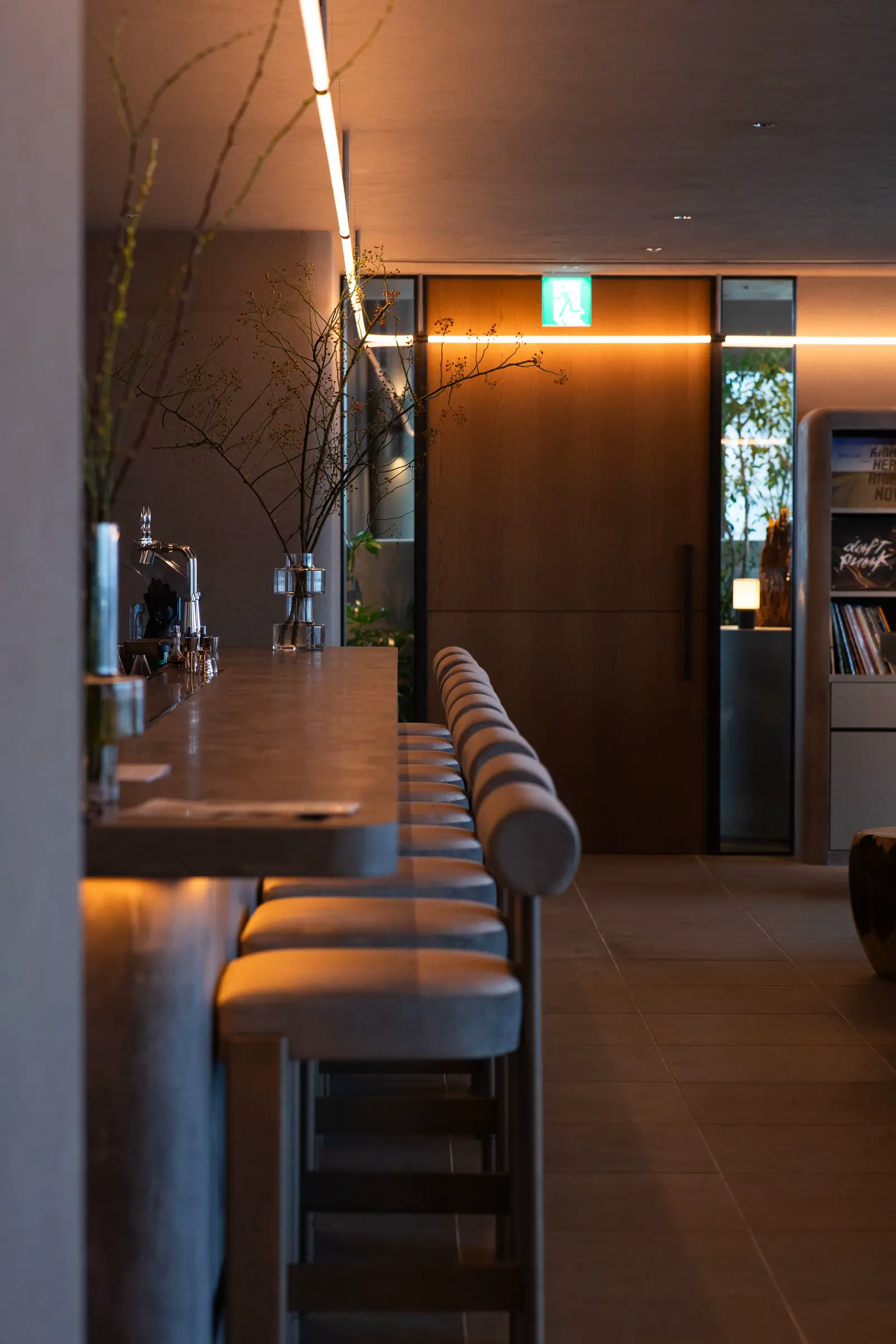 Warm cozy lounge interior with ambient commercial lighting at 100 to 200 lux creating intimate hospitality atmosphere