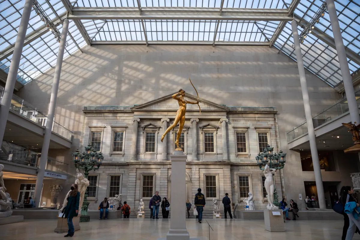 Skylit sculpture court at the Metropolitan Museum of Art in New York with daylight and concealed fixture positions