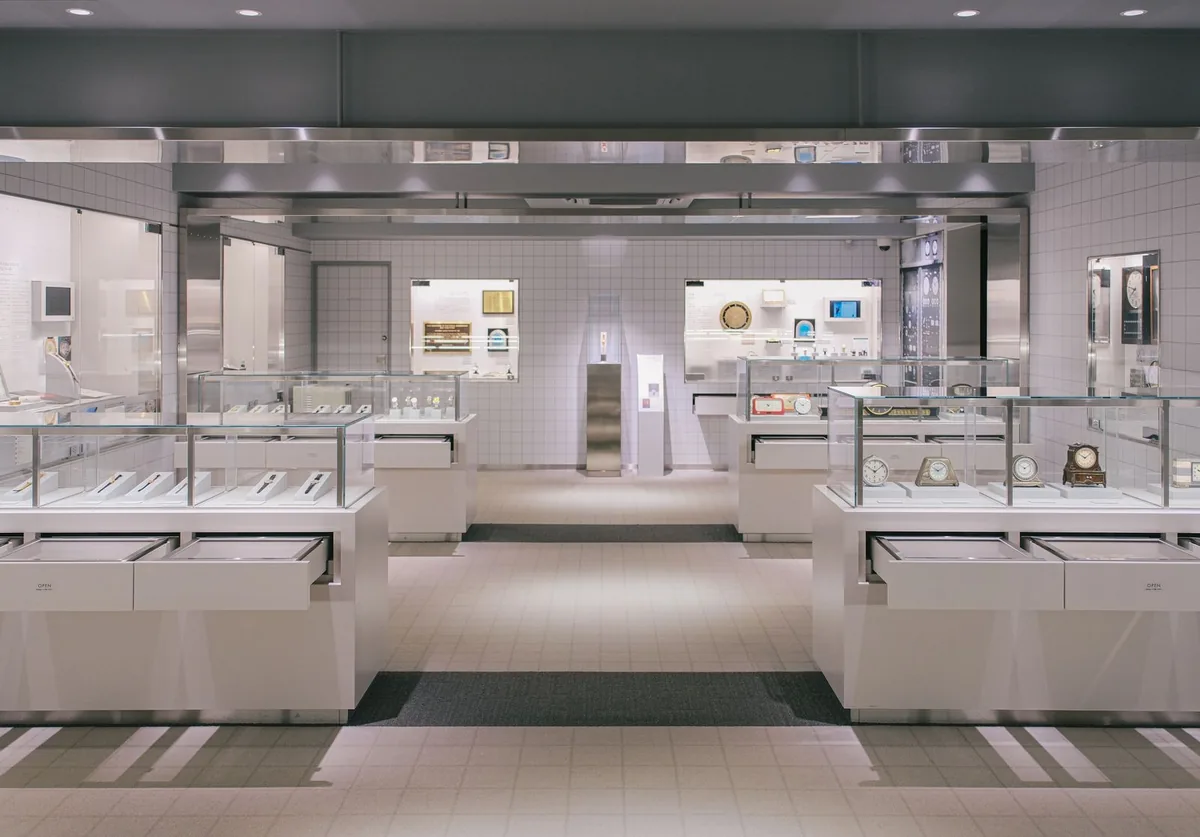 Luxury watch showroom with glass display cases lit by deep anti-glare retail display lighting to control reflections and glare